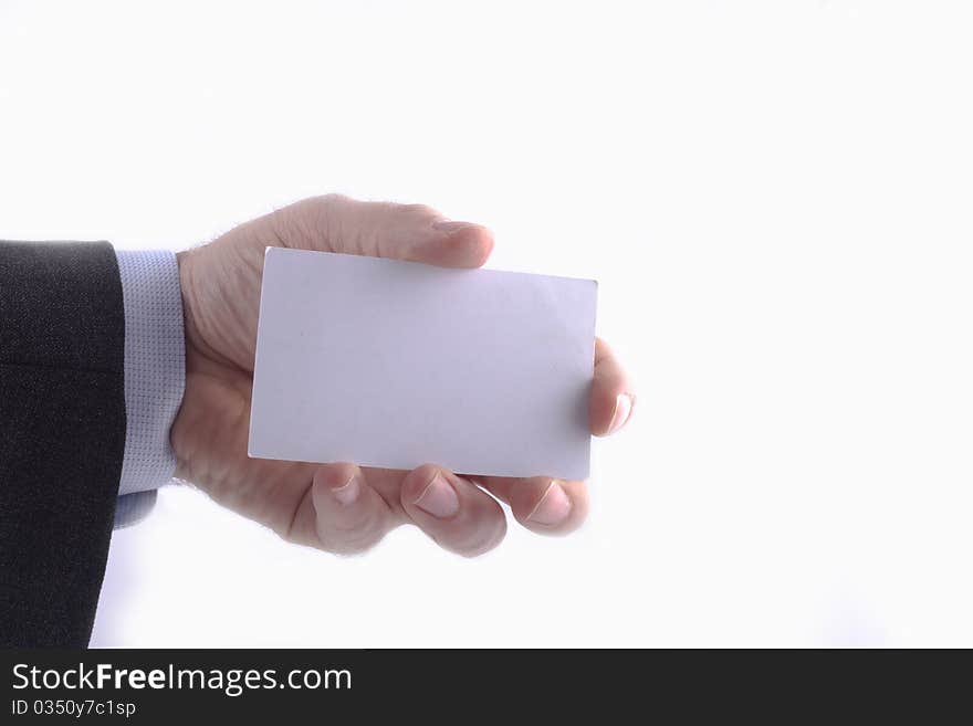 Businessman in grey suit and a blue shirt shows professional business card with copy space, shallow dept of field. Businessman in grey suit and a blue shirt shows professional business card with copy space, shallow dept of field