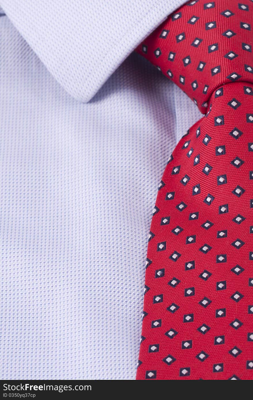 Close up of a red business tie and a blue dress shirt. Close up of a red business tie and a blue dress shirt