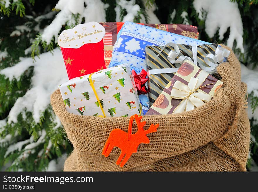 Bag of Christmas presents in the snow.