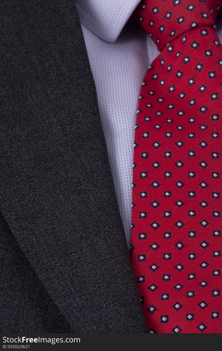 Close up of a red business tie and a blue dress shirt. Close up of a red business tie and a blue dress shirt