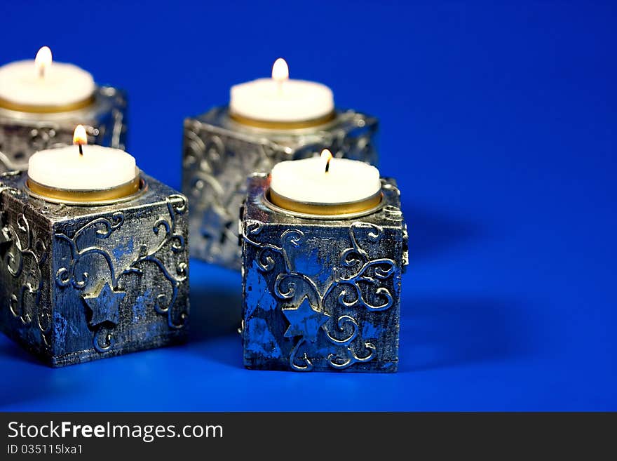 Christmas candle over blue background