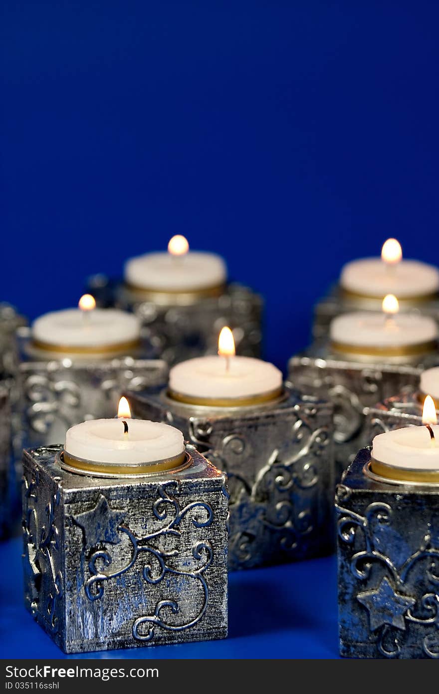 Christmas candle over blue background