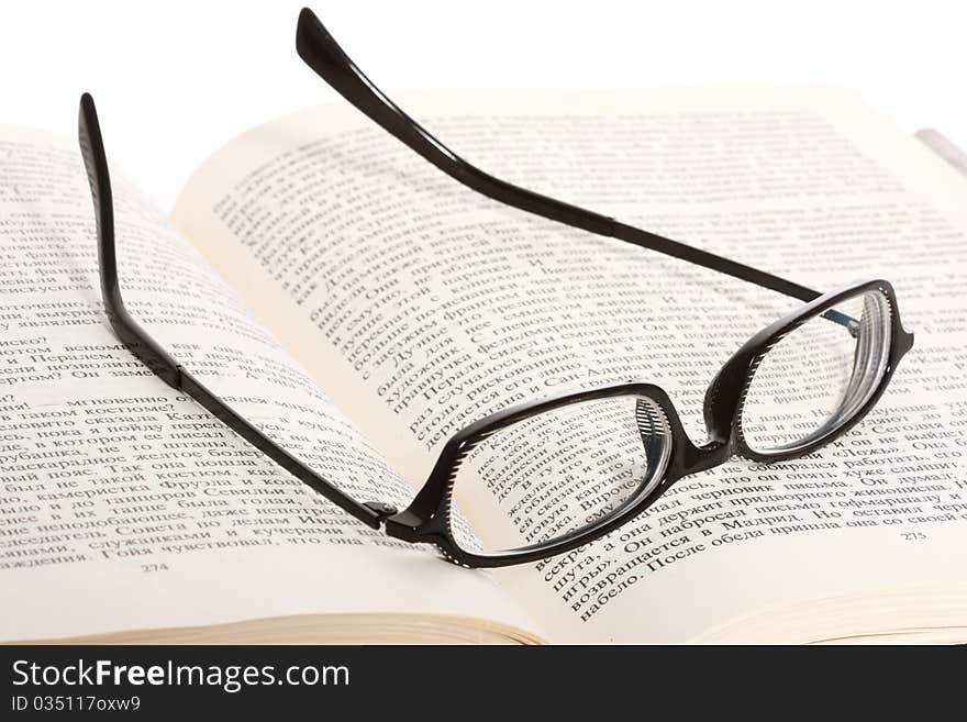 Spectacles Lying On The Opened Book