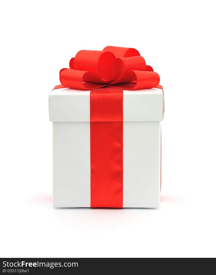 White gift box with a red bow on white background. White gift box with a red bow on white background