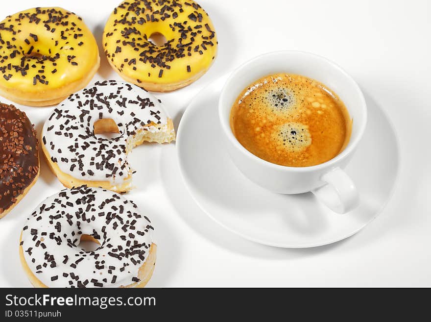 Donuts with cup of coffee on white background