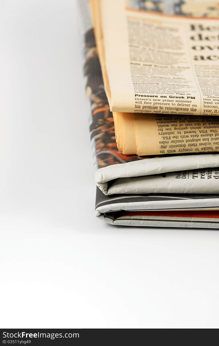 Various newspapers over white background