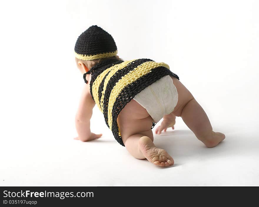 Baby in stripped dress crawling away. Baby in stripped dress crawling away