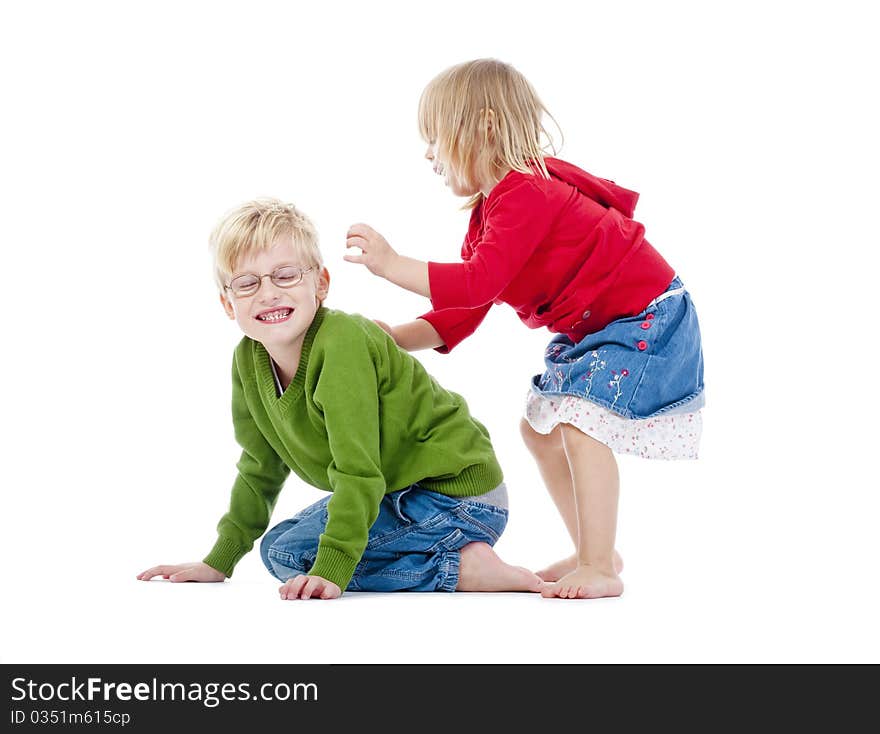 Two young siblings fooling around with each other - isolated on white. Two young siblings fooling around with each other - isolated on white