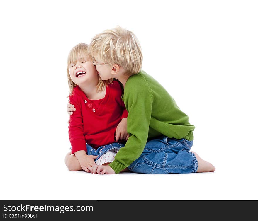 Two young siblings fooling around with each other - isolated on white. Two young siblings fooling around with each other - isolated on white