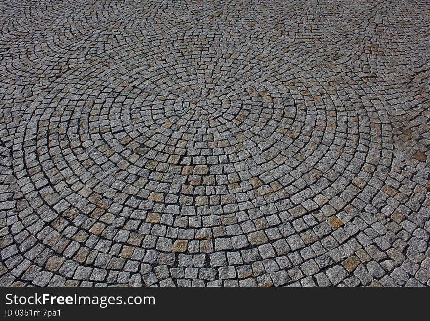 Background of the gray paving stones arranged in a circle. Background of the gray paving stones arranged in a circle