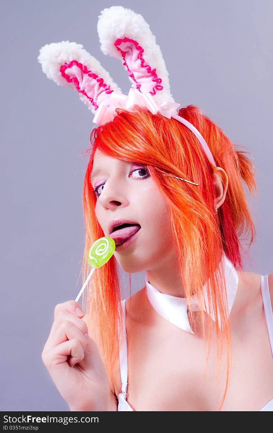 Woman easter bunny on gray background with orange hair. Woman easter bunny on gray background with orange hair