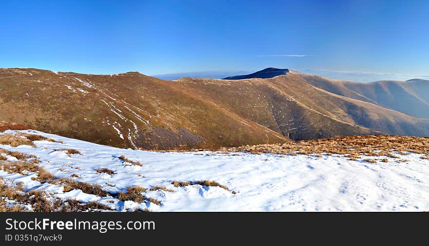 Mountain ridge and first snow panorama. Carpathians. Ukraine. Zakarpattya