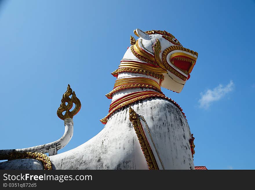 Antique guardian lion sculpture in front of the temple, thailand