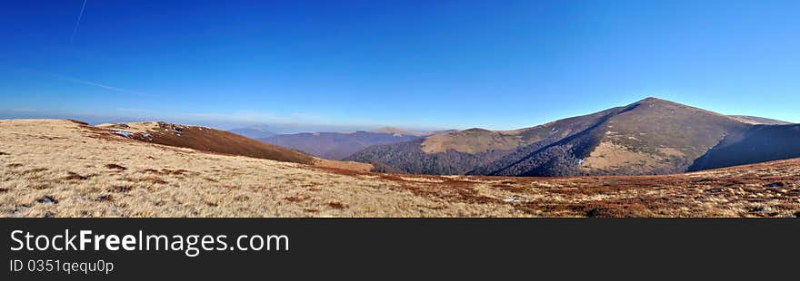 Autumn mountain meadows and peak view