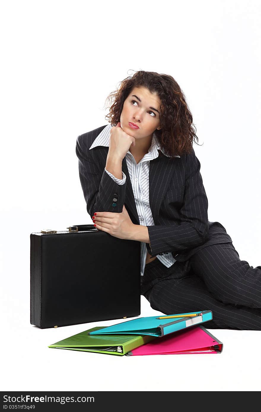 Business woman with suitcase sitting on a floor isolated on white