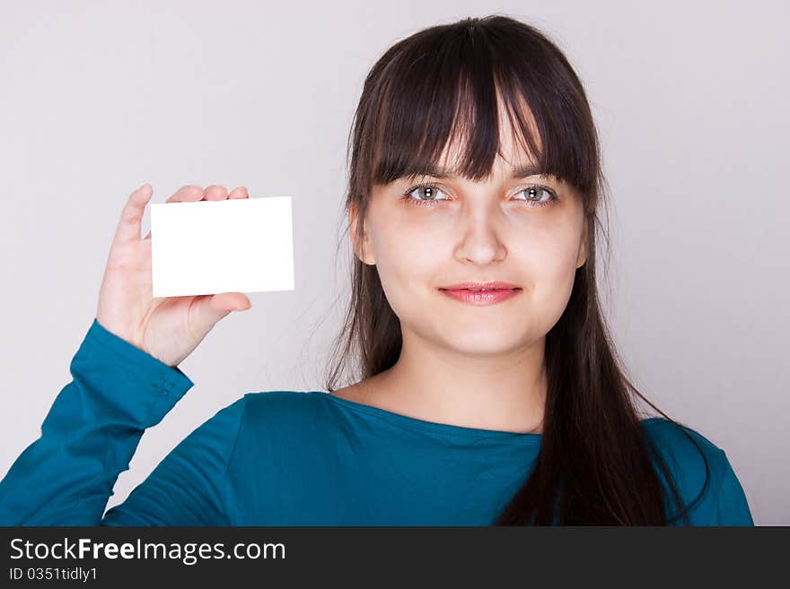 Attractive caucasion girl with business or gift card. Selective focus. Space for text available. Attractive caucasion girl with business or gift card. Selective focus. Space for text available.