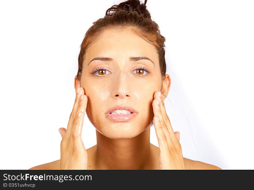 Young female cleaning her face