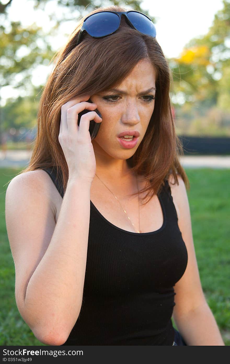 Young redhead on her mobile phone. Young redhead on her mobile phone