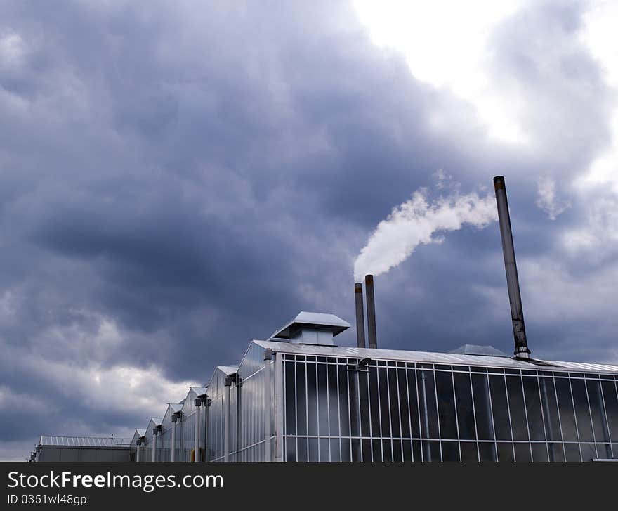 Greenhouse with smoking chimney