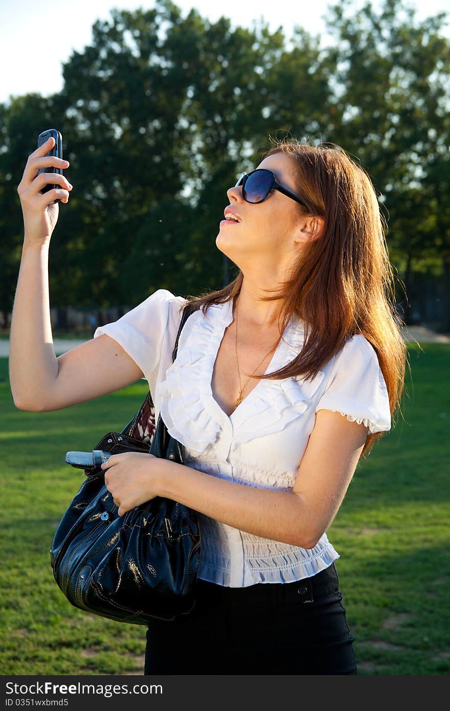 Young redhead on her mobile phone. Young redhead on her mobile phone