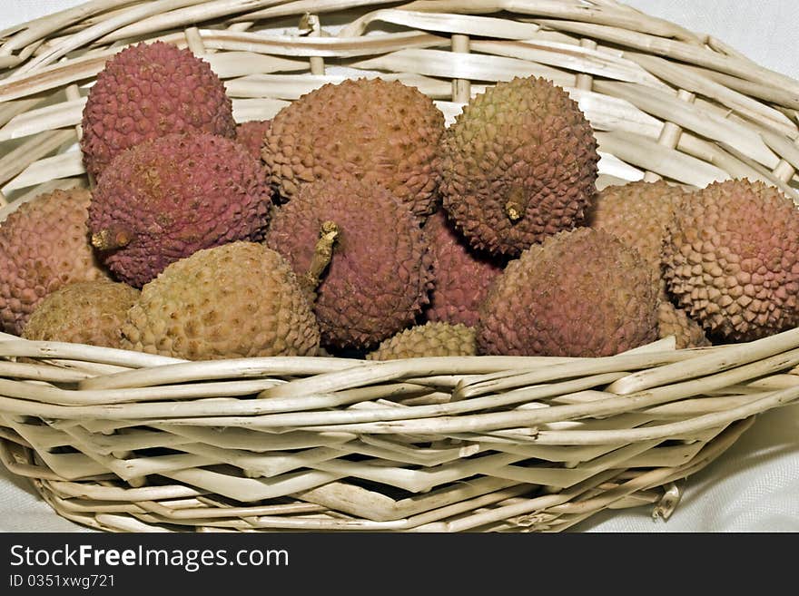 A close up of lychee fruit in a basket. A close up of lychee fruit in a basket