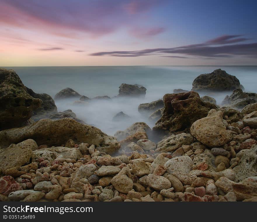 Sea coast in the summer, a sunset over the sea