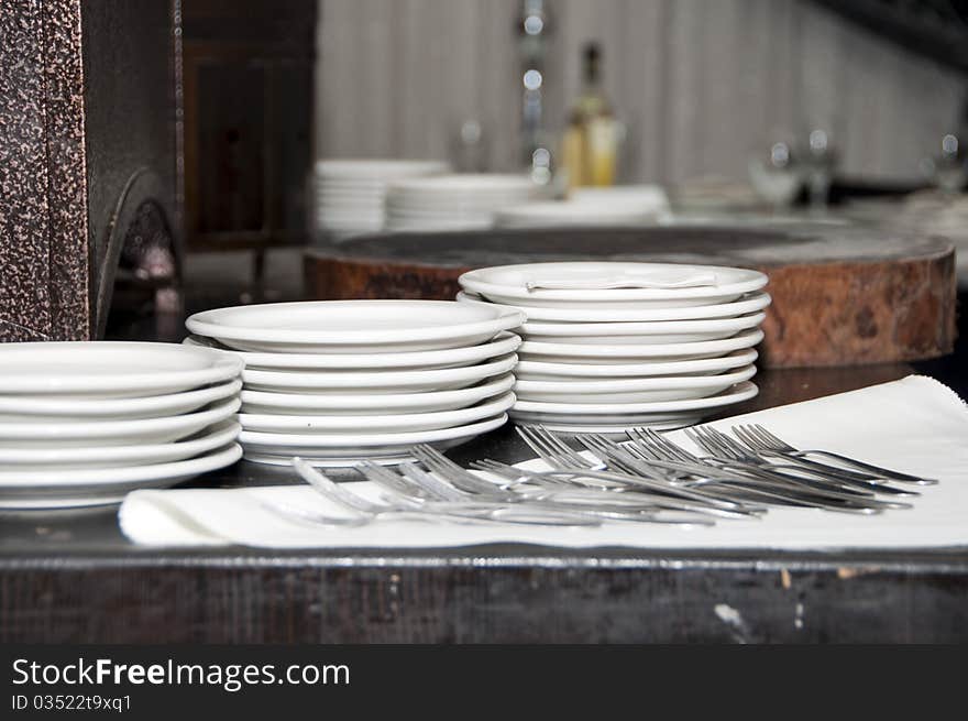 Plates forks on the table before distribution. Plates forks on the table before distribution