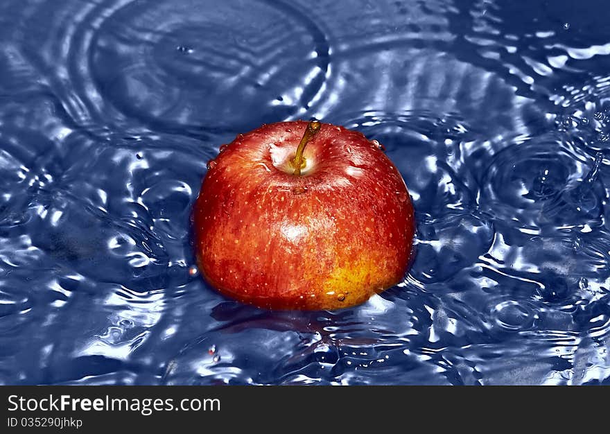 Red Apple in water with splash