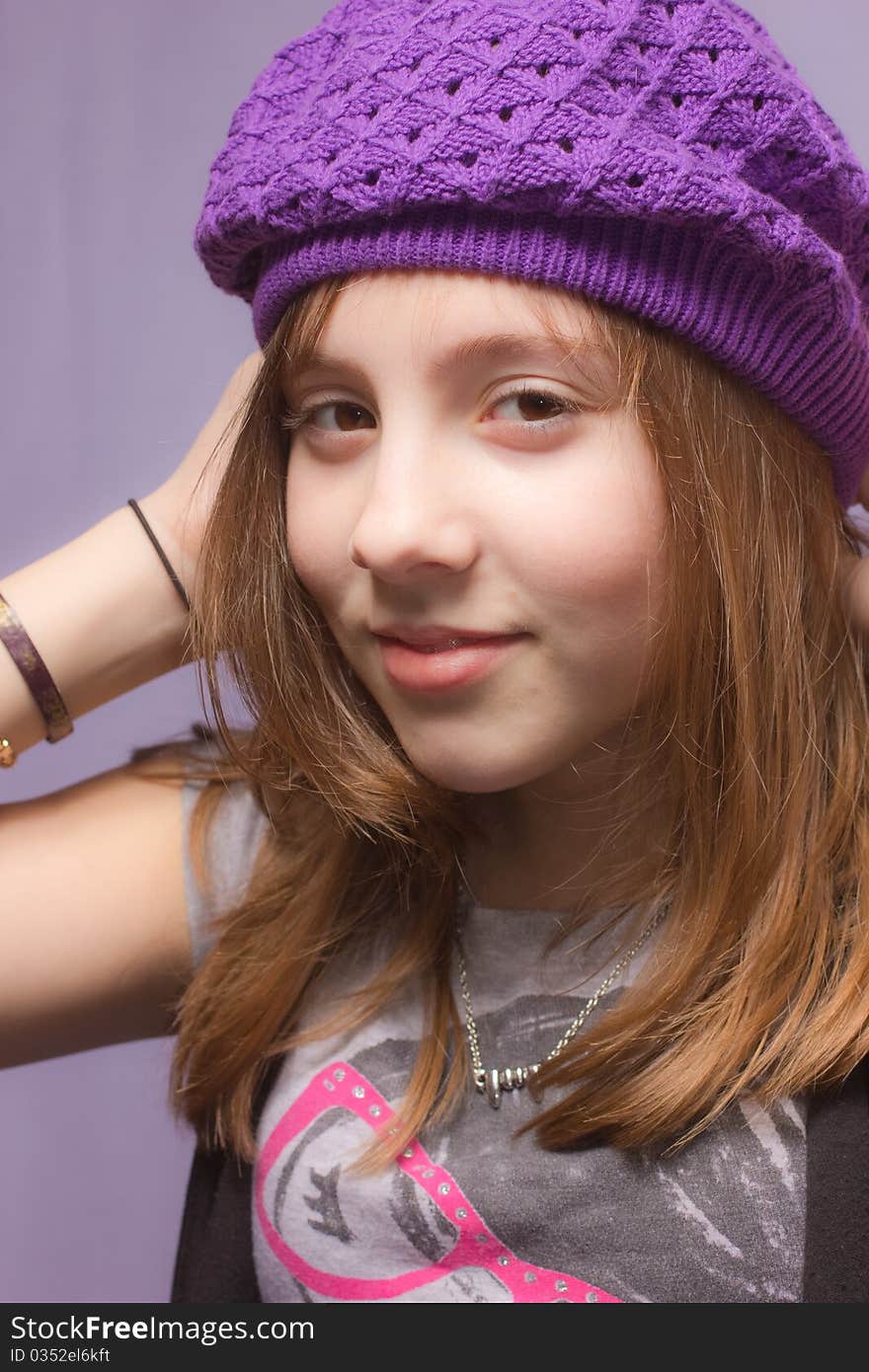 A girl wearing a purple hat. A girl wearing a purple hat