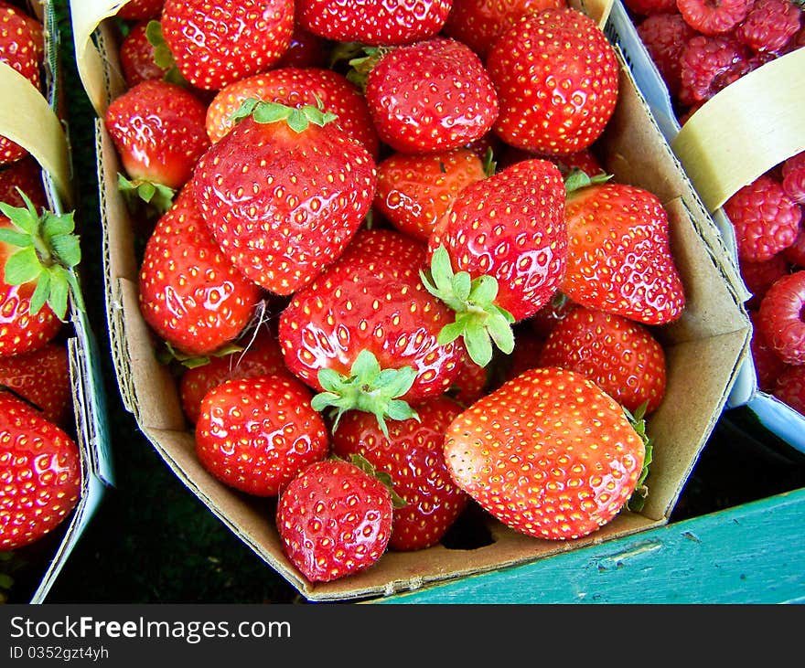 Strawberry in a market with raspberry