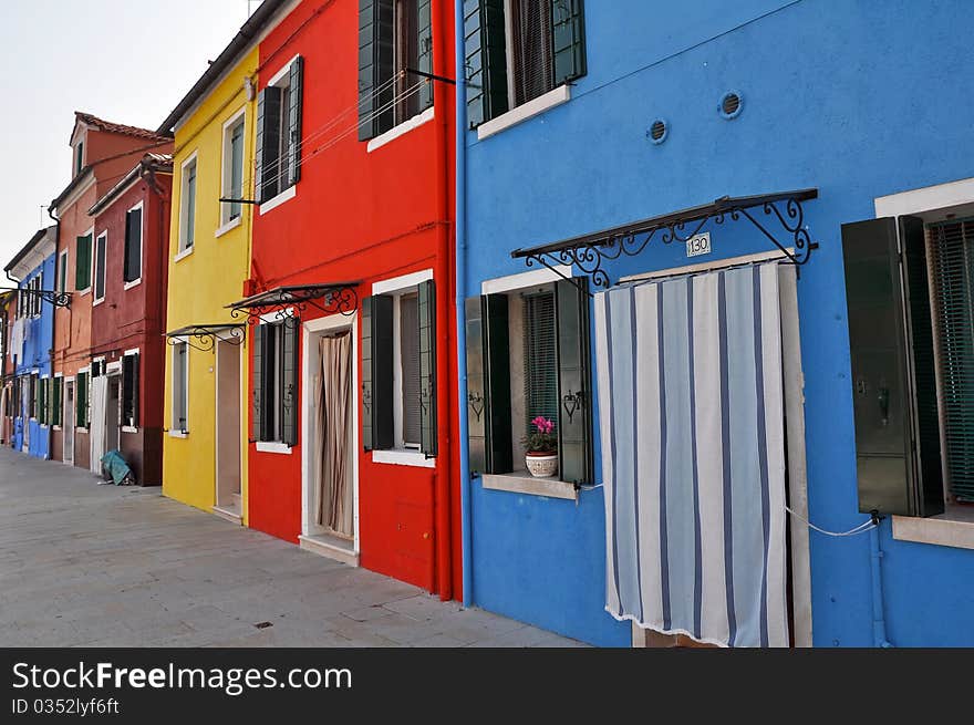 Row of houses on a small colorful island Burano near Venice, Italy. Row of houses on a small colorful island Burano near Venice, Italy.