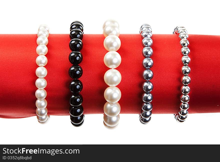 Women's bracelets on the red hat on a white background