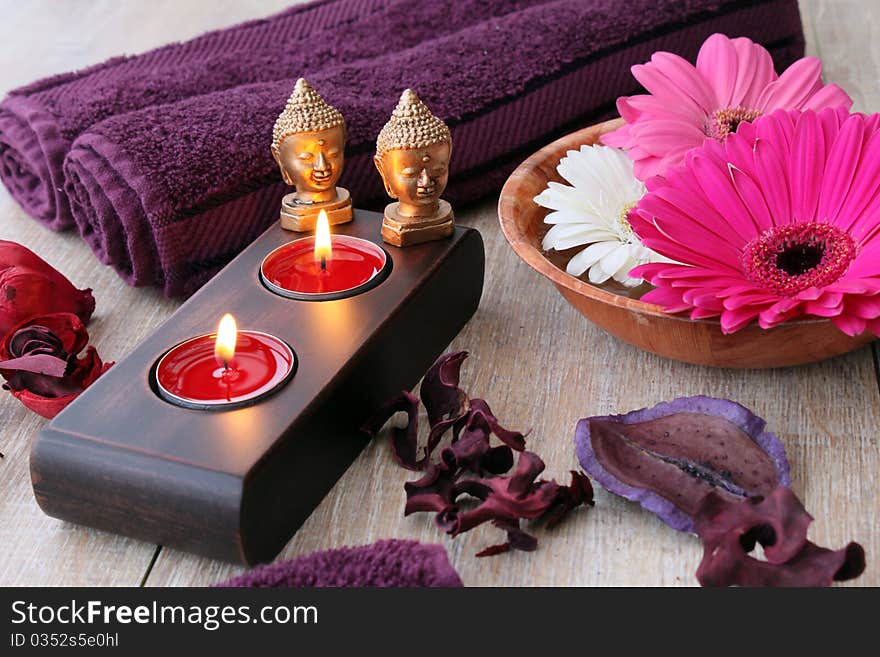 Towels candles and flowers in a spa area. Towels candles and flowers in a spa area