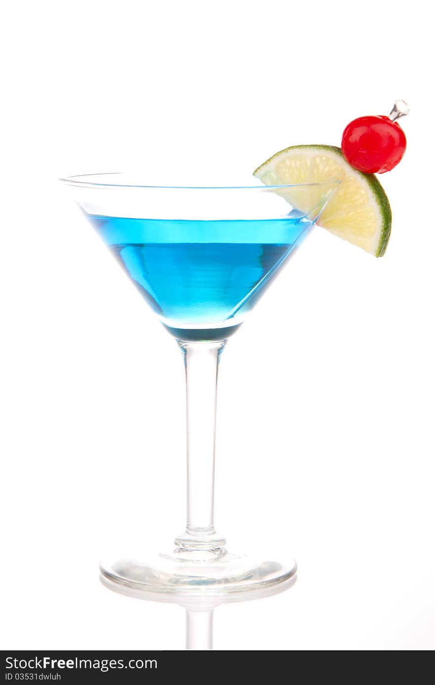 Blue Martini cocktail with gin, vodka, blue curacao, pineapple juice, pink grapefruit juice, lime and classic red cherry isolated on a white background