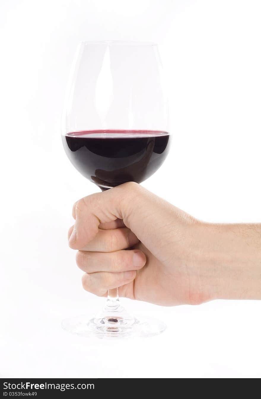 Hand holding glass of red whine. Studio shot. White background. Hand holding glass of red whine. Studio shot. White background.