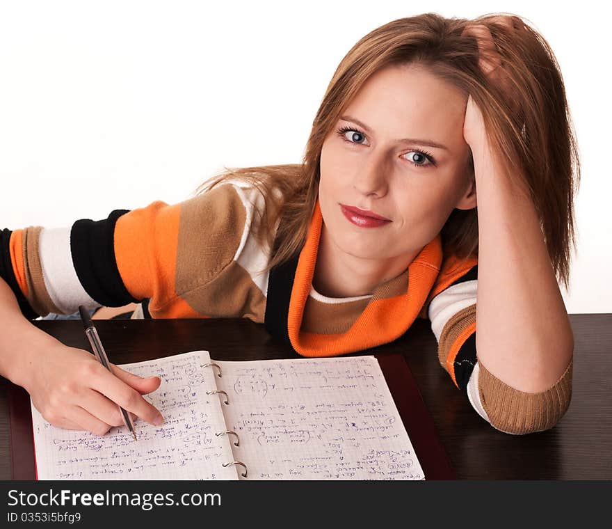 Young tired student on the desk with her notes dreaming looking at camera. Young tired student on the desk with her notes dreaming looking at camera