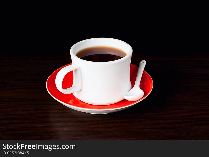 A cup of tea on the table. Black dackground. studio shot. A cup of tea on the table. Black dackground. studio shot.