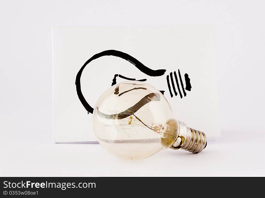 Real light bulb and illustration light bulb in paper with white background. Real light bulb and illustration light bulb in paper with white background