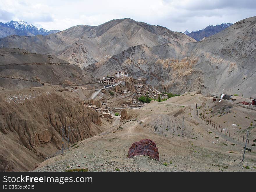 A beautiful scene with houses situated in the valley and mountains. A beautiful scene with houses situated in the valley and mountains.