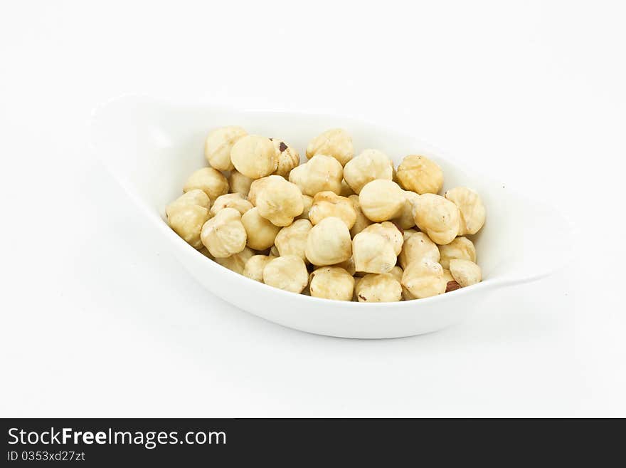 Hazelnut in a bowl on white background. Hazelnut in a bowl on white background