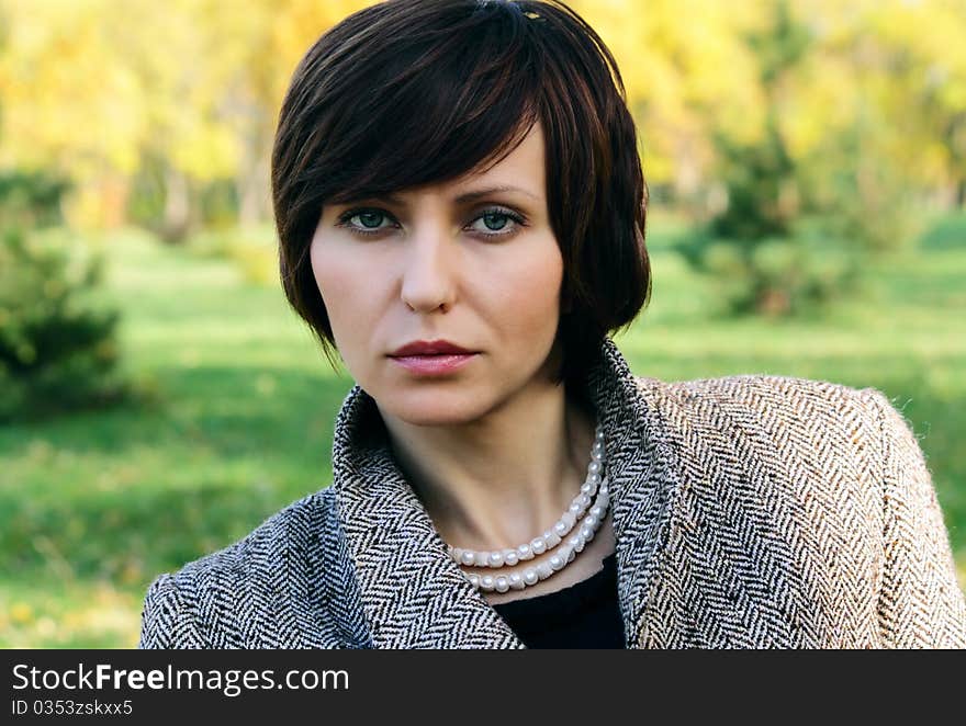 Woman in the autumn forest in the coat