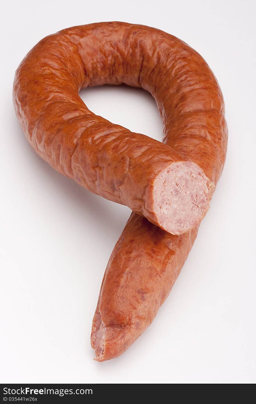 Fatty home smoked sausage on a white background.