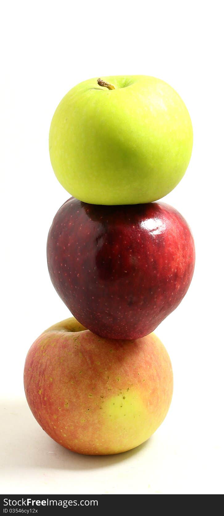 Three apples on white background on top of each other