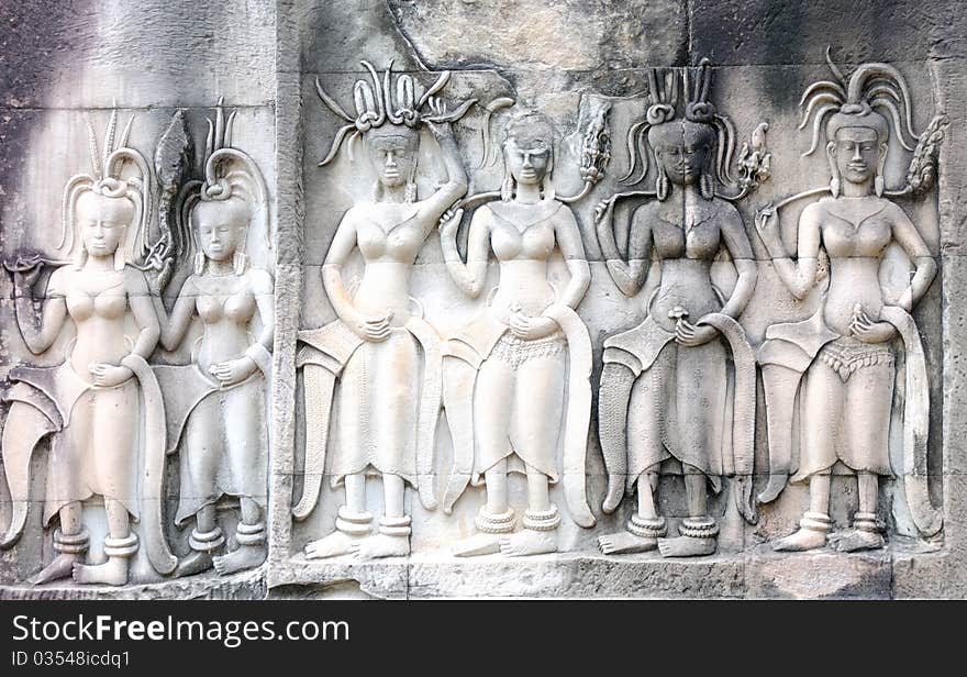 Statuette of woman on the wall in Anghor Wat temple in Cambodia