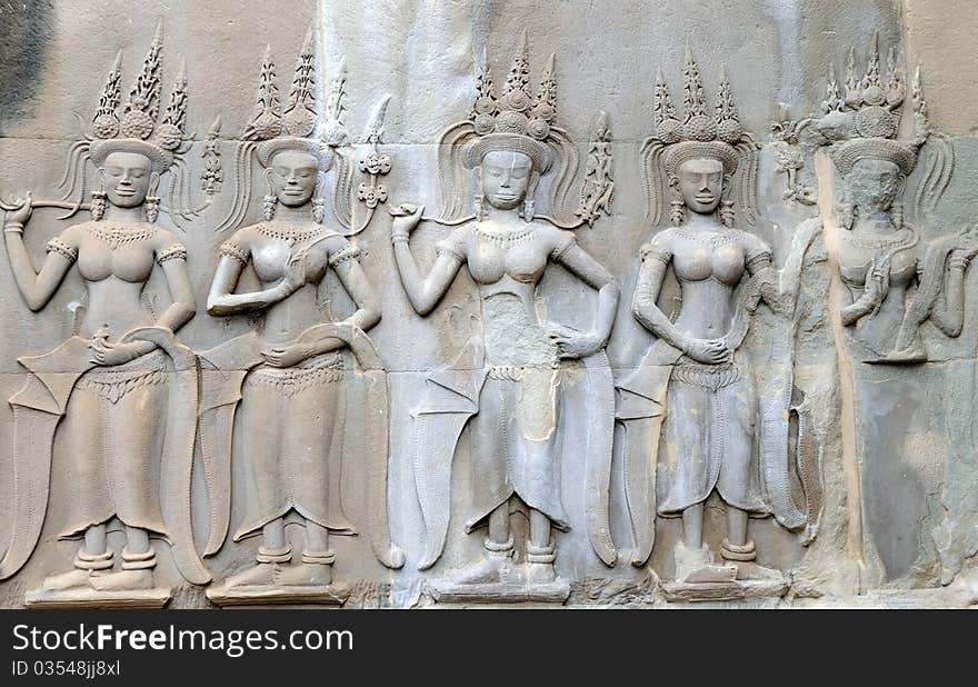 Statuette of woman on the wall in Anghor Wat temple in Cambodia