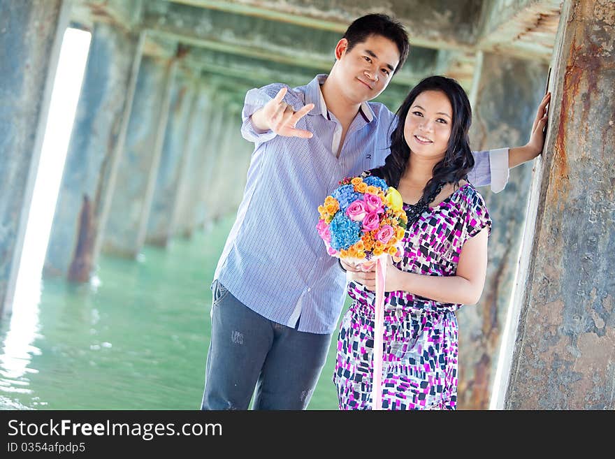 Portrait of bride and groom making I Love you Sign. Portrait of bride and groom making I Love you Sign