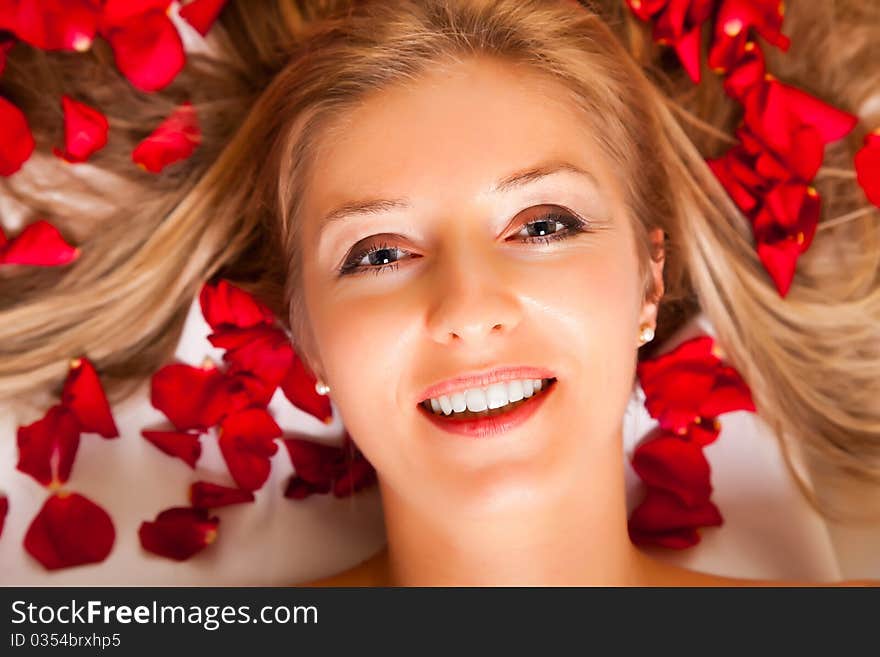 Woman laying with rose petals