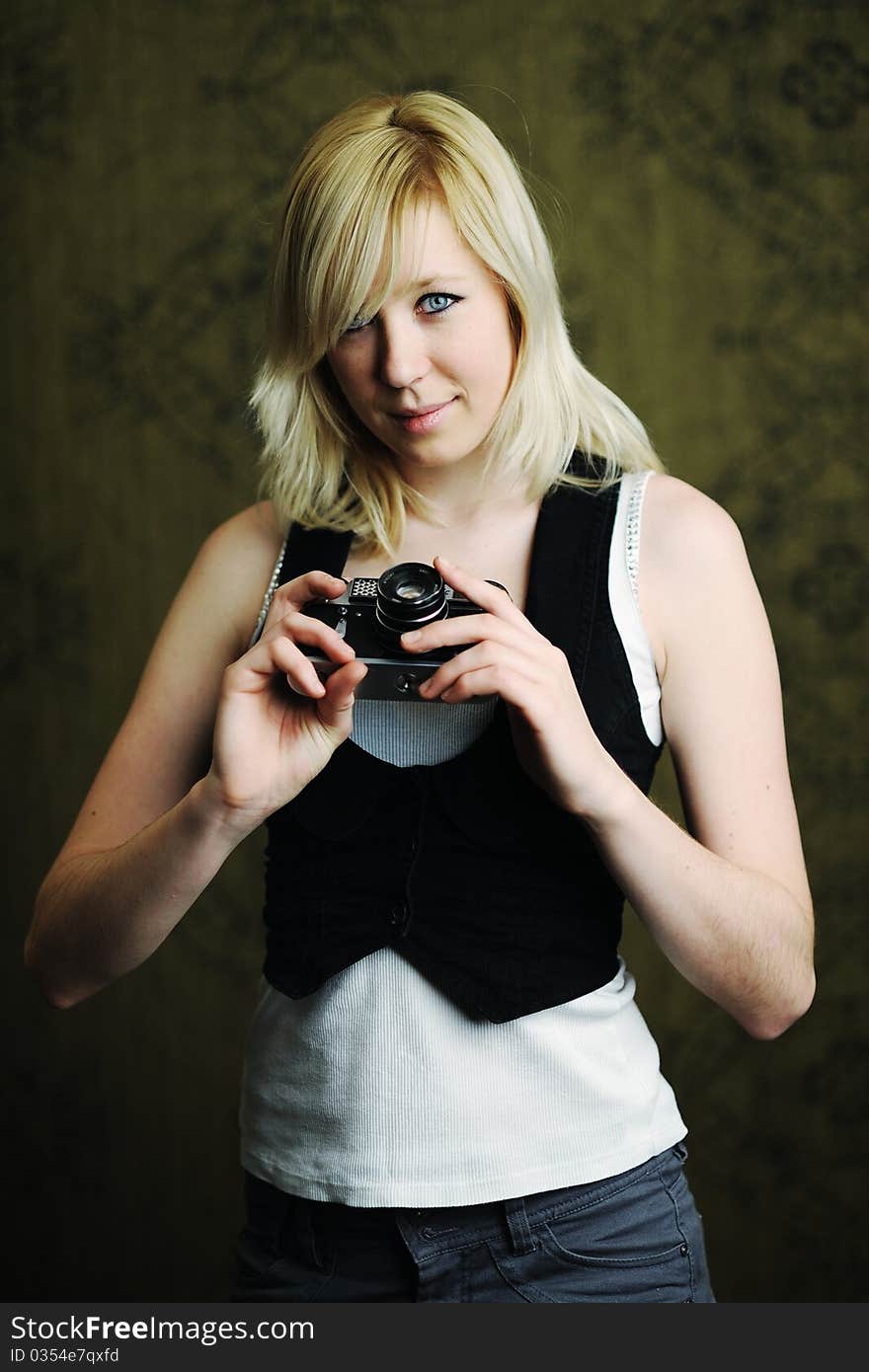 An image of a young woman with a camera. An image of a young woman with a camera