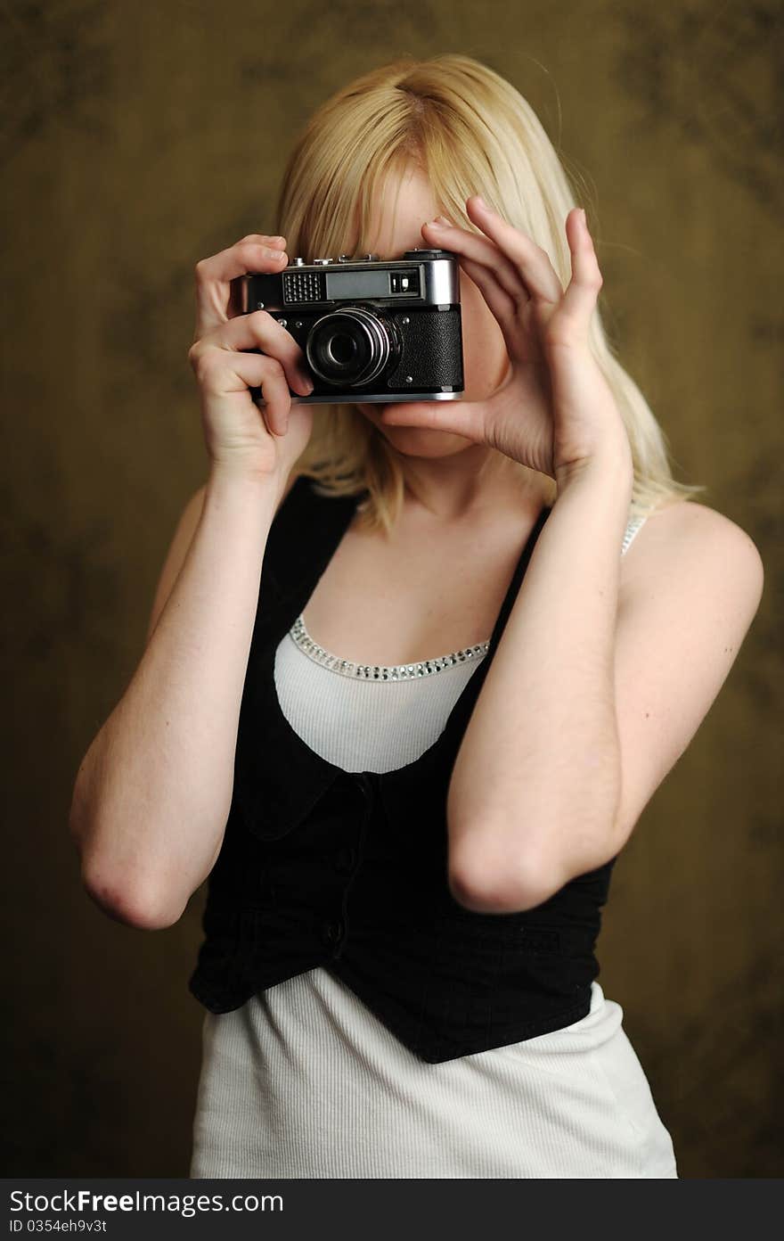 An image of a young woman with a camera. An image of a young woman with a camera