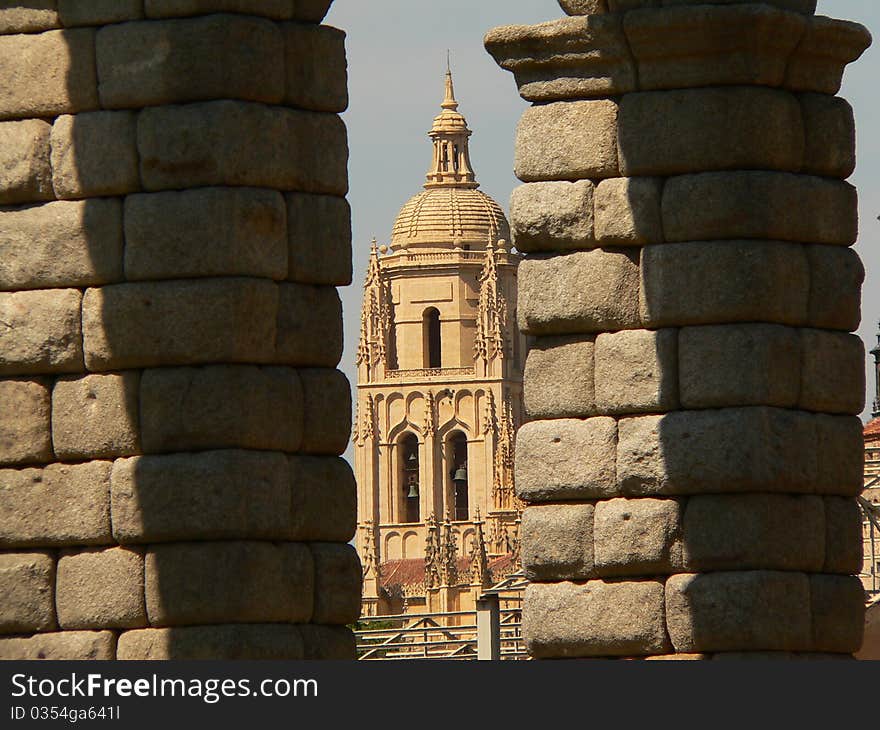 View of the cathedral through the arches of the aqueduct in segovia in spain. View of the cathedral through the arches of the aqueduct in segovia in spain